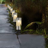 Solarbetriebene Stabbeleuchtung aus Edelstahl entlang eines Gartenwegs, seitliche Perspektive