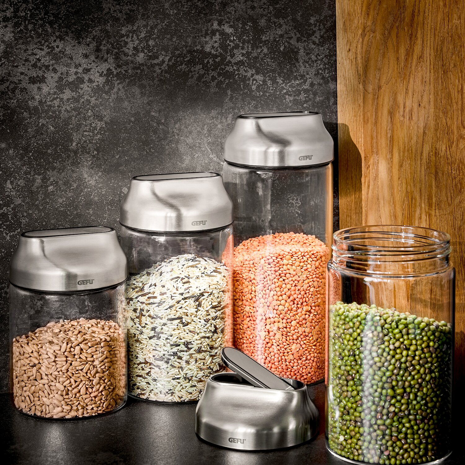 GEFU Vorratsdosen 700 ml, 2er-Set KIPPO Vorratsdosen aus Glas mit Edelstahl-Deckeln, gefüllt mit verschiedenen Lebensmitteln, aus seitlicher Perspektive fotografiert.