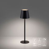 Schwarze Akku-Tischleuchte EURIA mit konischem Schirm, frontal abgebildet, auf einem Tisch stehend. Symbole für USB, IP54, Touch, Akku, LED und Memory sind sichtbar.