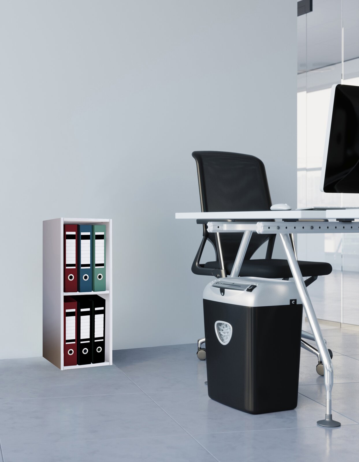 Schwarzer Aktenvernichter unter einem weißen Bürotisch in modernem Büro, seitliche Ansicht auf Augenhöhe mit Ordnerregal im Hintergrund