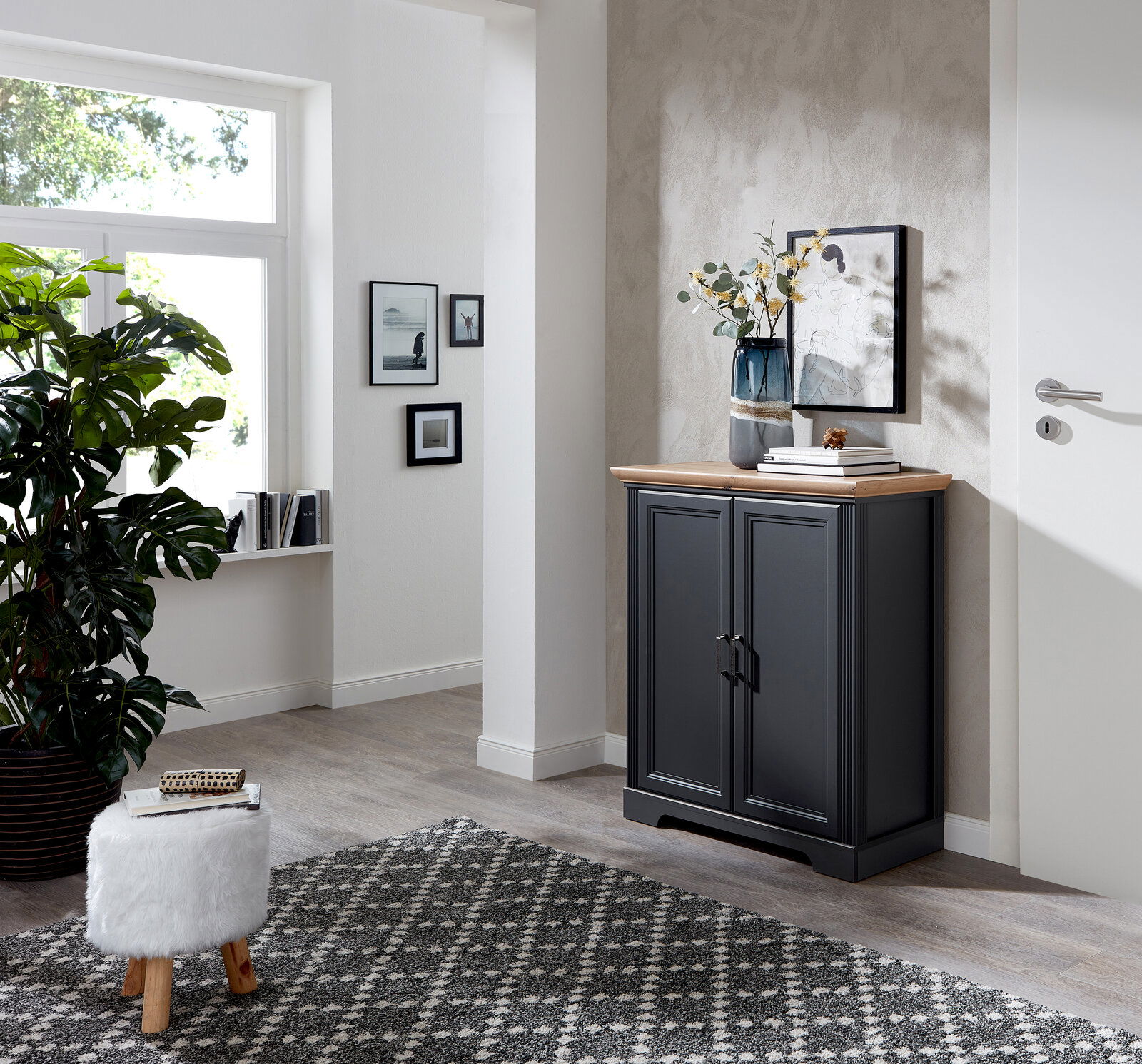 Schwarze Kommode aus der Serie JUDITH in einem modernen Wohnzimmer, seitliche Perspektive