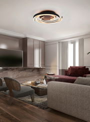 Moderne LED-Deckenleuchte CAYA in einem stilvollen Wohnzimmer, von unten betrachtet.