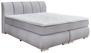 Graues Boxspringbett mit gestepptem Kopfteil, seitliche Perspektive