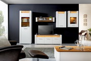 Moderne woonkamermeubels in wit met houten accenten, bestaande uit vitrinekasten, een tv-meubel en een wandplank, gezien vanaf de voorkant.