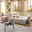 Ecksofa London in einem modernen Wohnzimmer, beige gepolstert, mit Kissen und Decke, aus der Perspektive von vorne links.