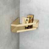 Goldene Eckablage Meleto mit zwei Tuben, an einer grauen Wand montiert, seitliche Perspektive.