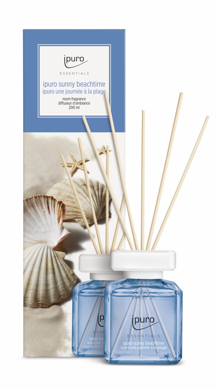 Raumduft Sunny Beachtime von ipuro, 200ml, mit Muscheln und Sand im Hintergrund, aus frontaler Perspektive.