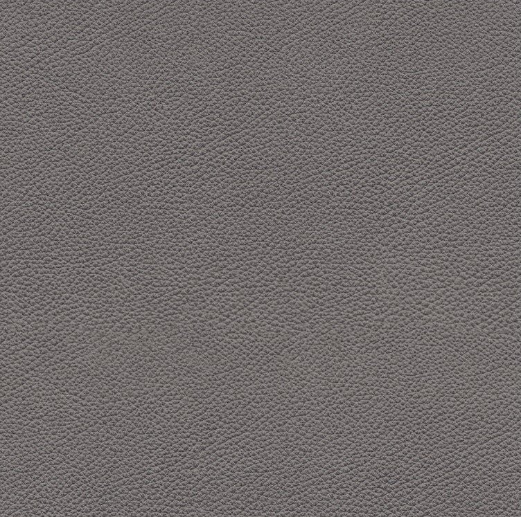 Nahaufnahme einer grauen Lederstruktur, perspektivisch von oben betrachtet.