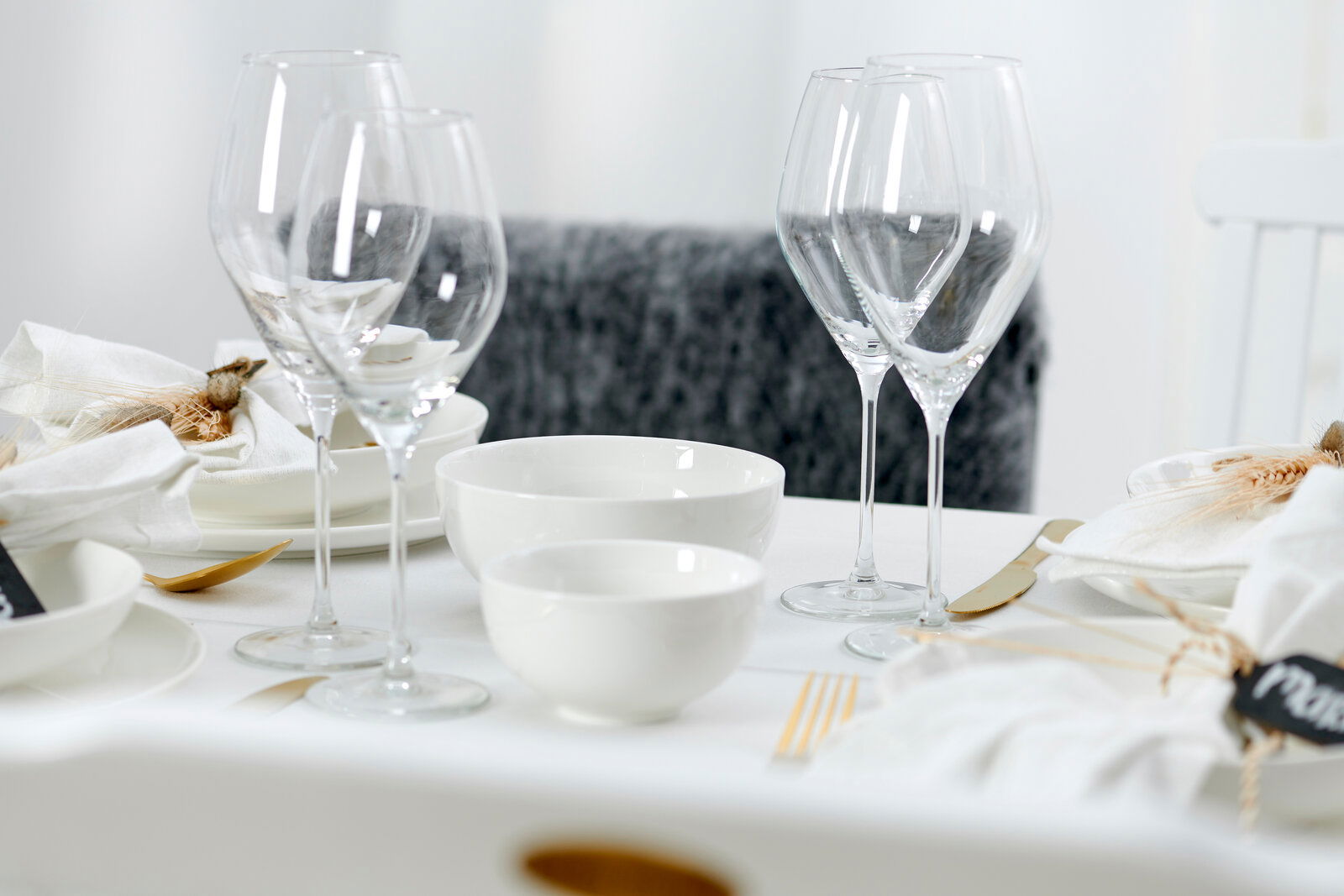 Elegante Müsli-Schale Skagen 15cm auf einem stilvoll gedeckten Tisch, umgeben von Weingläsern und weißem Geschirr, aus seitlicher Perspektive.