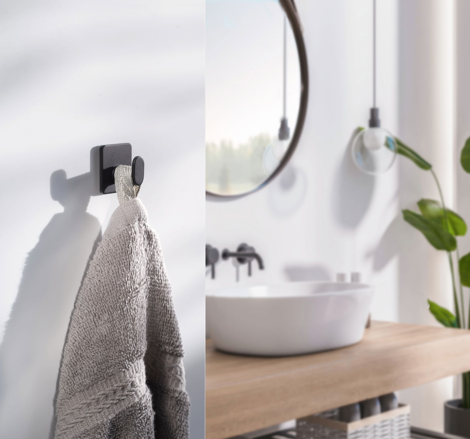 Schwarzer, selbstklebender Haken an einer weißen Wand, von der Seite fotografiert, mit einem Handtuch daran hängend.