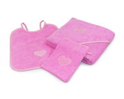 Dreiteiliges Kinderset in Rosa mit Herzmotiv, bestehend aus einem Lätzchen, einem Handtuch und einem Waschlappen, aus der Vogelperspektive fotografiert.