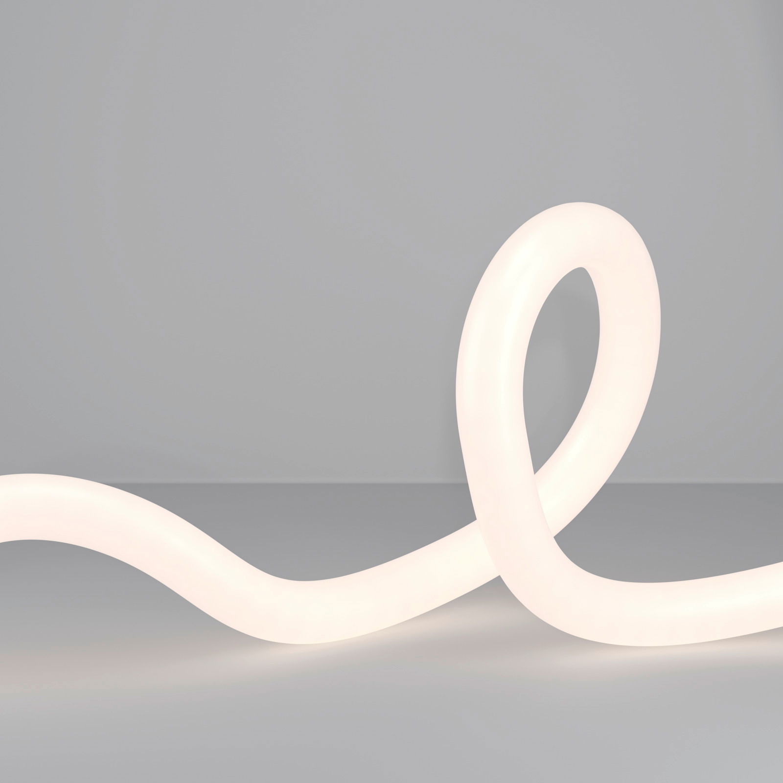 LED-Lichtschlauch in geschwungener Form auf grauem Hintergrund, seitliche Perspektive