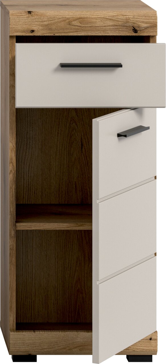 Schmaler Holzschrank mit weißer Schublade und weißer Tür mit schwarzen Griffen, Tür halb geöffnet und Innenraum sichtbar, Ansicht schräg von vorn