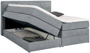 Graues Boxspringbett mit geöffnetem Bettkasten, seitliche Perspektive