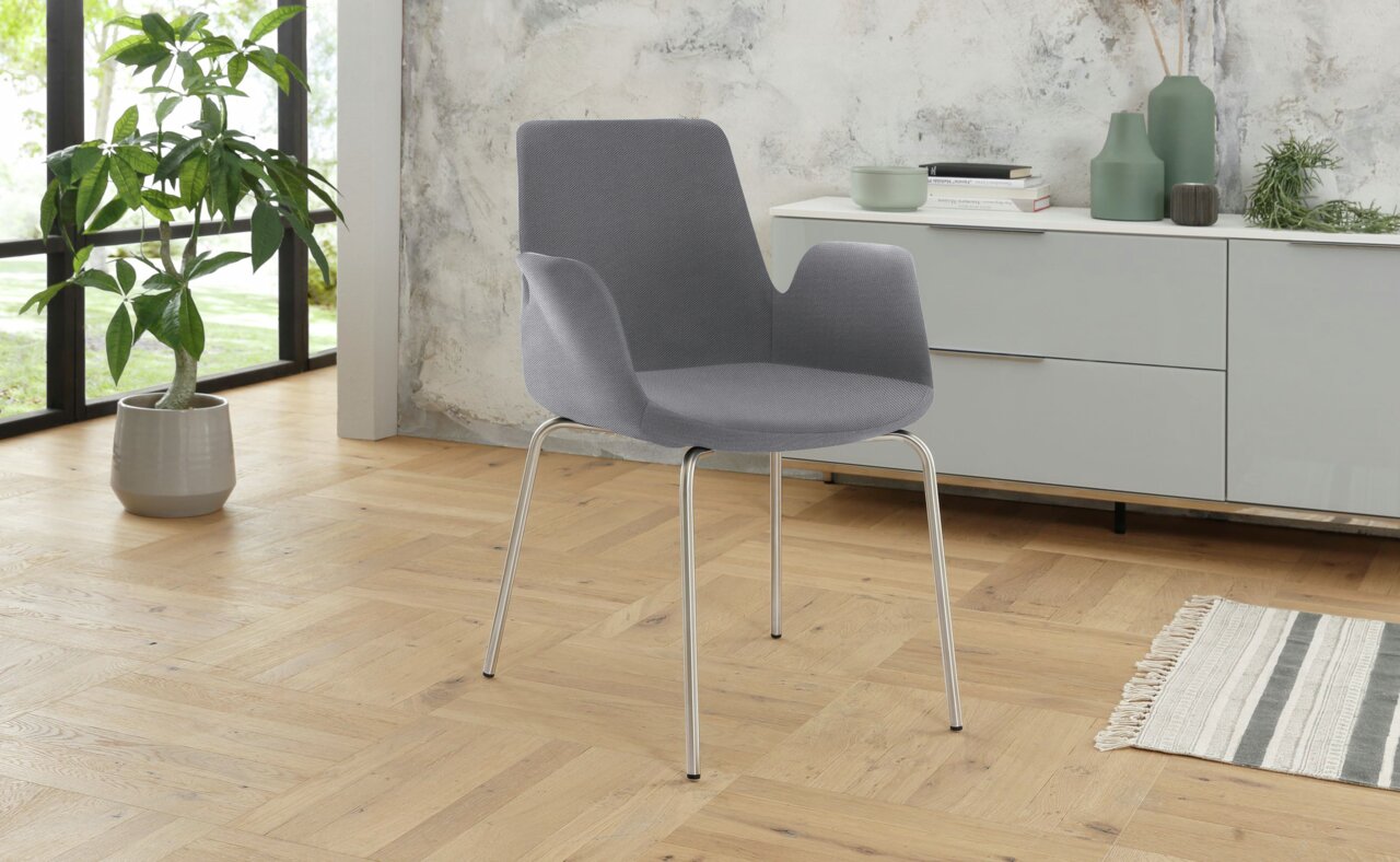 Venda Besuchersessel MY HELIOS Grauer Besuchersessel mit Metallbeinen in einem modernen Raum, seitliche Perspektive