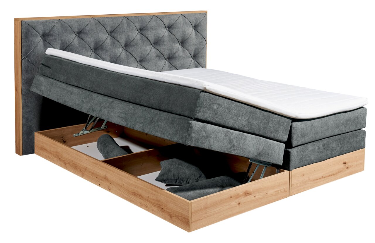Boxspringbett mit grauem Stoffbezug und Stauraum, seitliche Perspektive