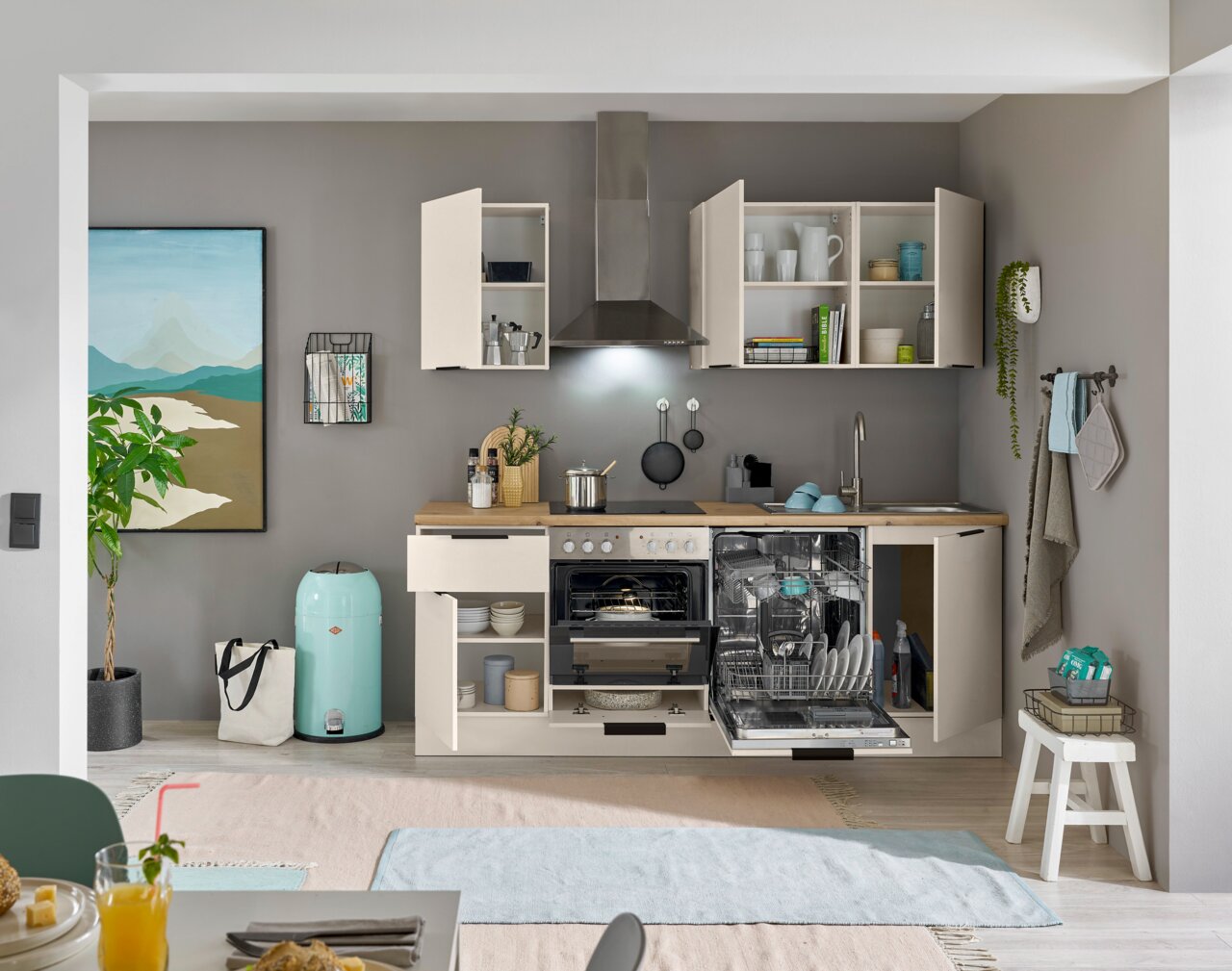 Moderne Küchenzeile mit offenen Schränken, Geschirrspüler und Herd, frontal betrachtet.