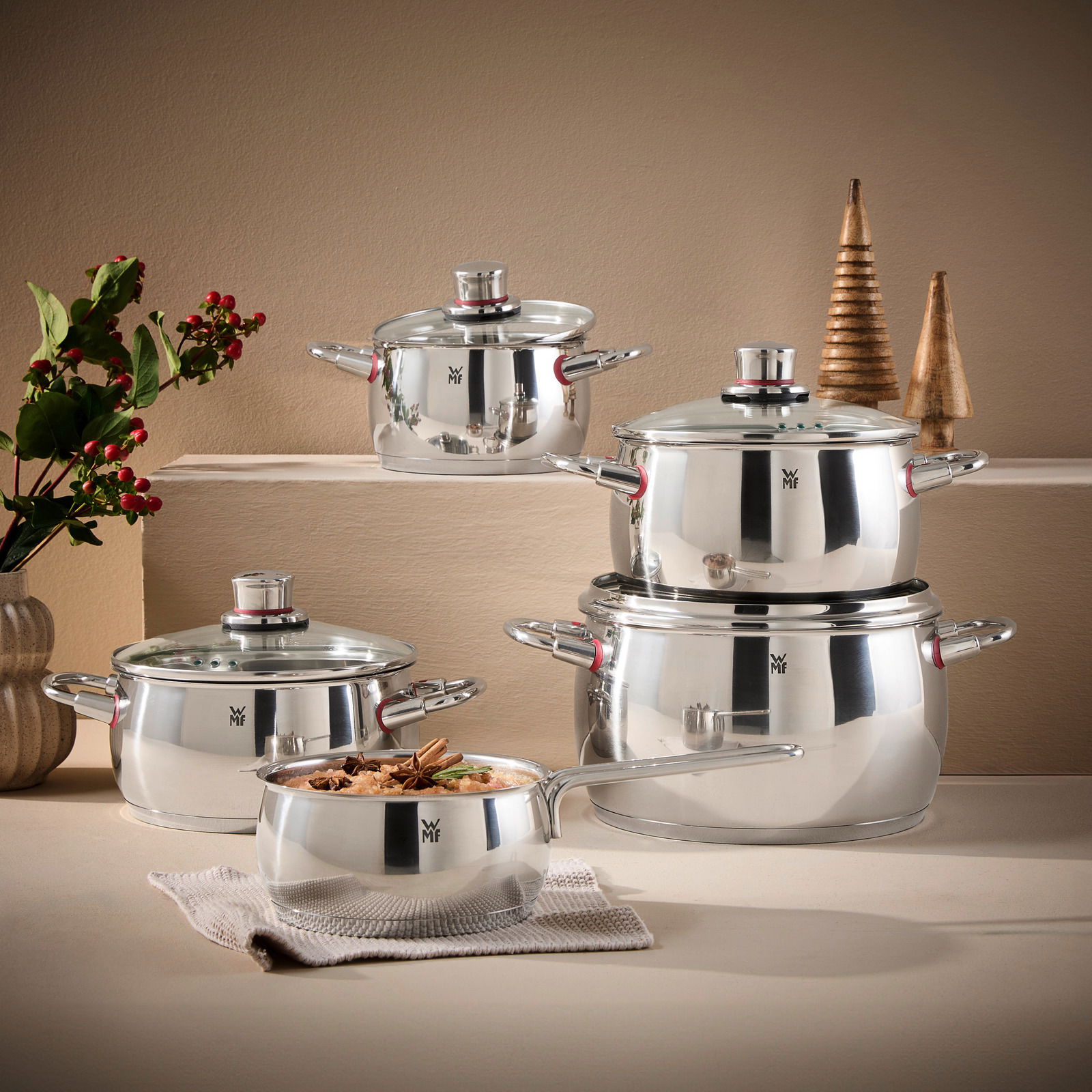 Topfset Quality One 5-tlg. aus Edelstahl, bestehend aus vier Töpfen und einer Stielkasserolle, in einer eleganten Küchenumgebung präsentiert. Seitliche Perspektive.