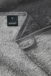 Graues Handtuch von JOOP! in Nahaufnahme, zeigt die weiche Textur und das Etikett, Perspektive von oben.