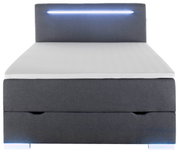 Vooraanzicht van een grijs boxbed met ledverlichting aan het hoofdeinde.