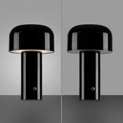 Schwarze Akku-Tischleuchte AGNES, zylindrische Form, Vorderansicht, eine Seite beleuchtet, andere Seite ausgeschaltet.