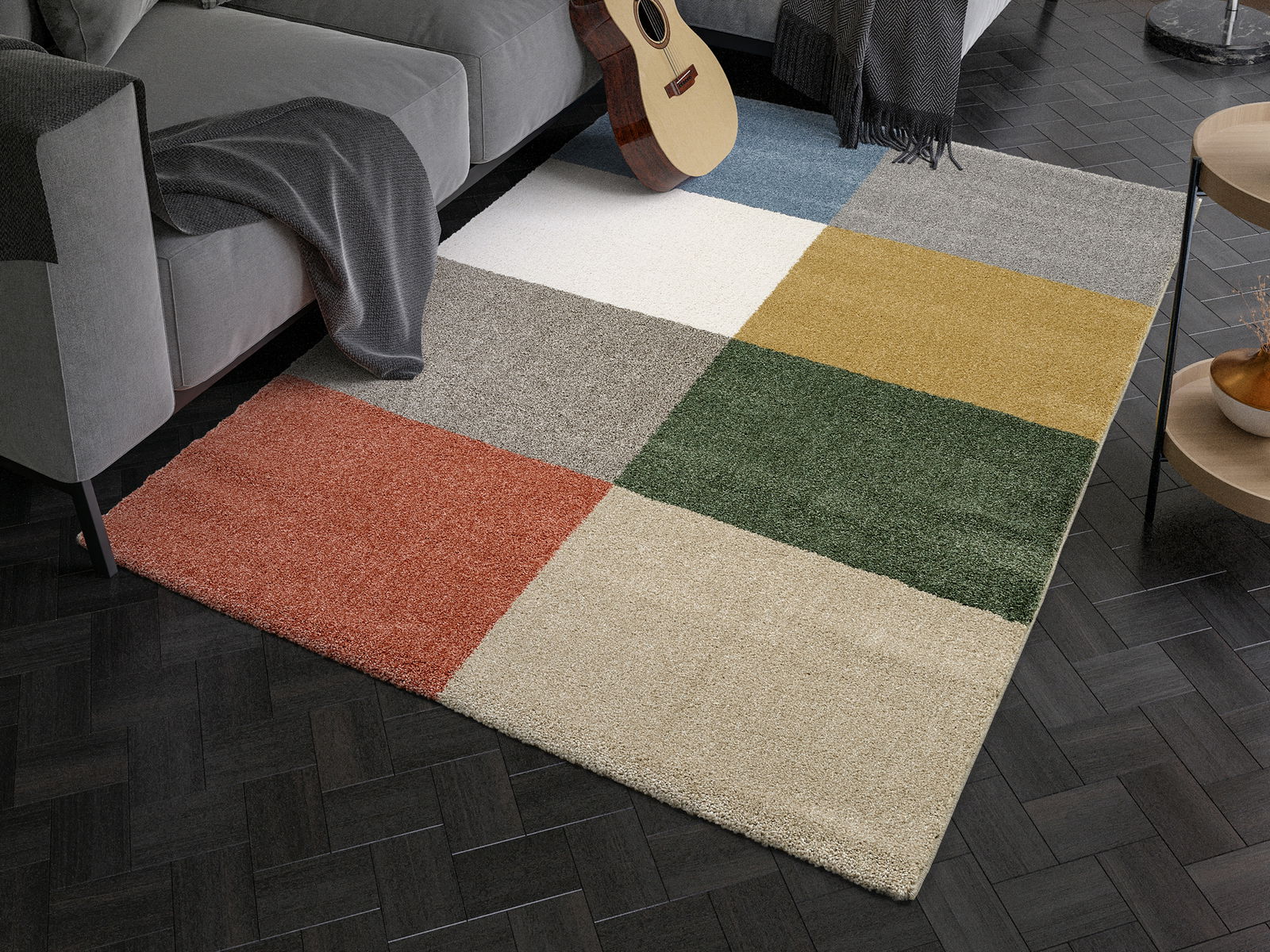 Vogelperspektive auf einen mehrfarbigen Uni-Teppich mit quadratischen Farbblöcken in einem modernen Wohnzimmer.
