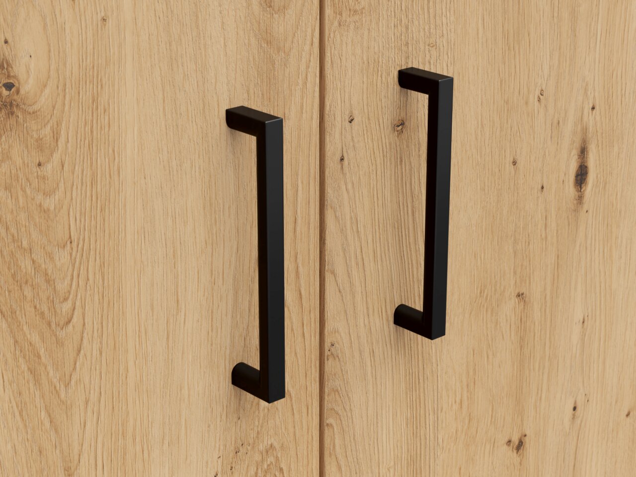 Nahaufnahme von zwei schwarzen Griffen auf einer Holzoberfläche, perspektivisch von vorne betrachtet.