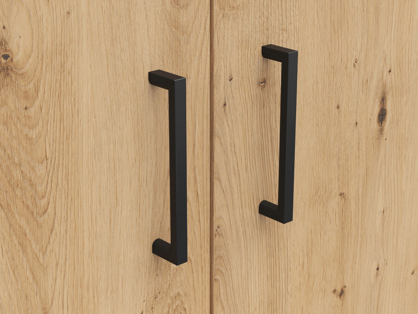 Nahaufnahme von zwei schwarzen Griffen auf einer Holzoberfläche, perspektivisch von vorne betrachtet.