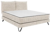 Beiges Boxspringbett mit gepolstertem Kopfteil, seitliche Perspektive