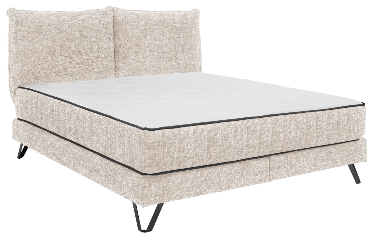 Beiges Boxspringbett mit gepolstertem Kopfteil, seitliche Perspektive