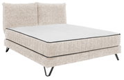 Beiges Boxspringbett mit gepolstertem Kopfteil, seitliche Perspektive