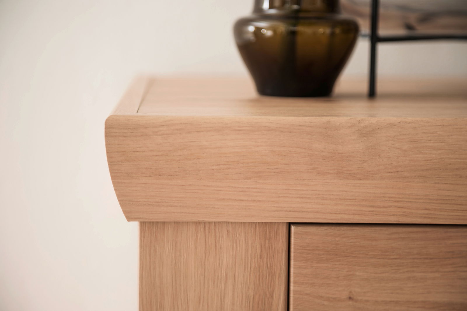 Nahaufnahme einer Holzmöbelecke mit dekorativer Vase, seitliche Perspektive