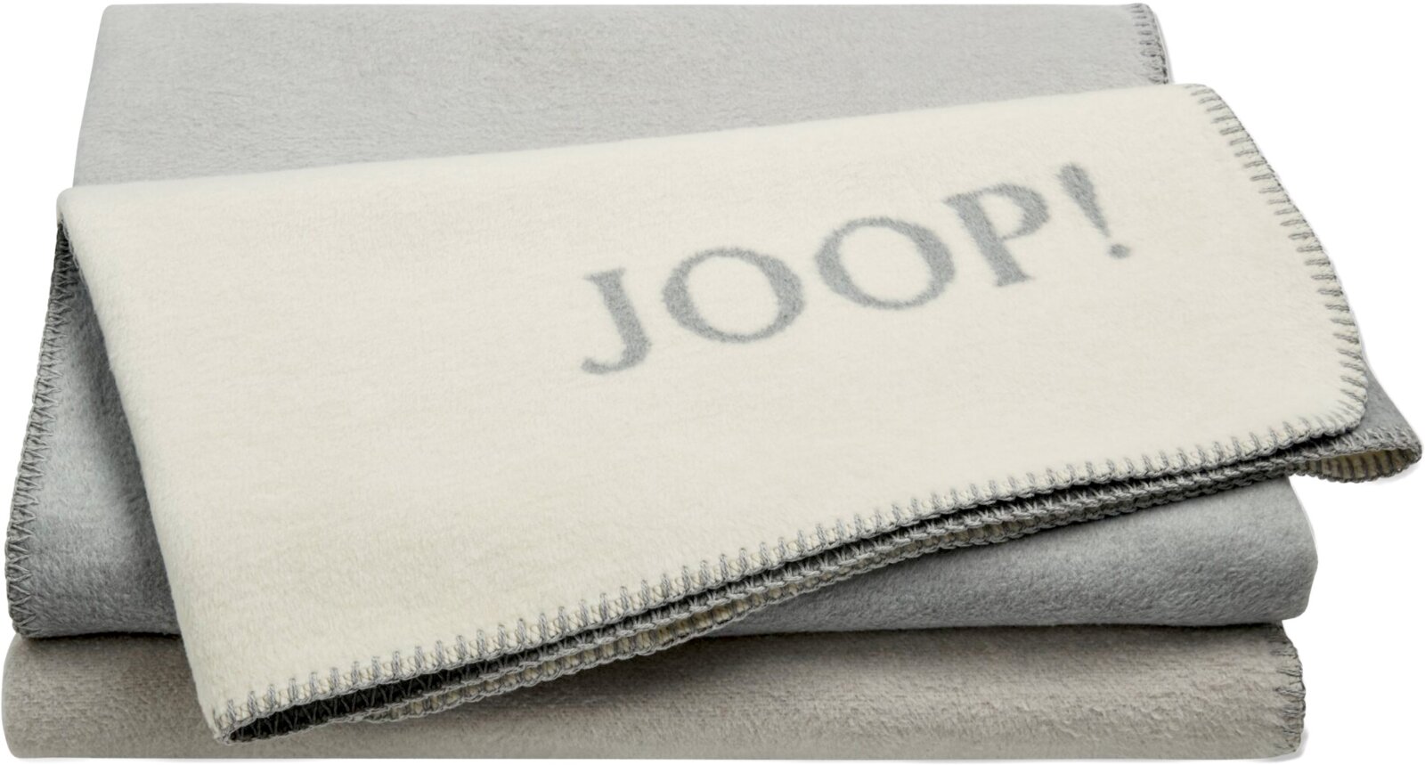 JOOP! Wohndecke 150x200cm Gefaltete JOOP! Wohndecke/Decke in Creme und Grau mit Zierstich-Kante, perspektivisch schräg von vorne oben aufgenommen.