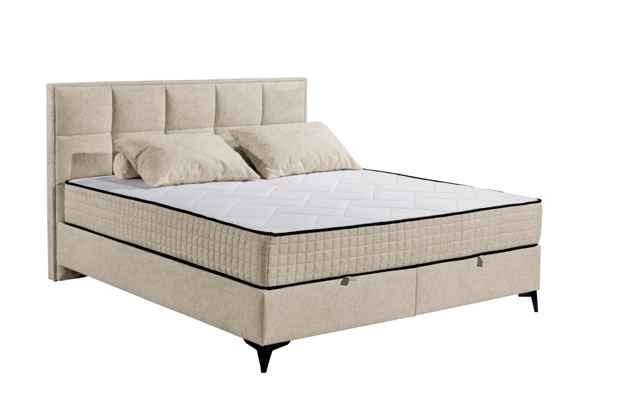 Beiges Boxbett mit gestepptem Kopfteil und zwei Kissen, seitliche Perspektive
