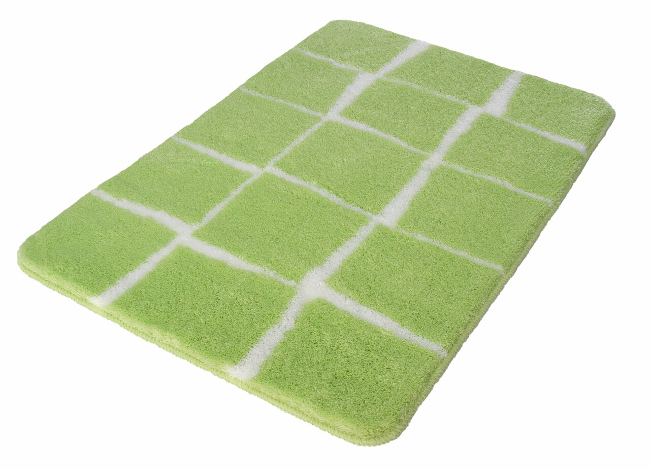 Grüner Badteppich mit weißem Karomuster, perspektivisch von schräg oben fotografiert.