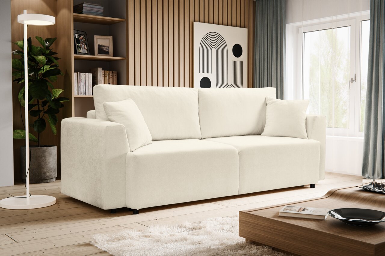 MID.YOU Schlafsofa POINT Modernes, cremefarbenes 3-Sitzer-Sofa mit breiten Armlehnen und weichen Rückenkissen im hellen Wohnzimmer, gezeigt in frontaler Perspektive mit leichter Ansicht von links.