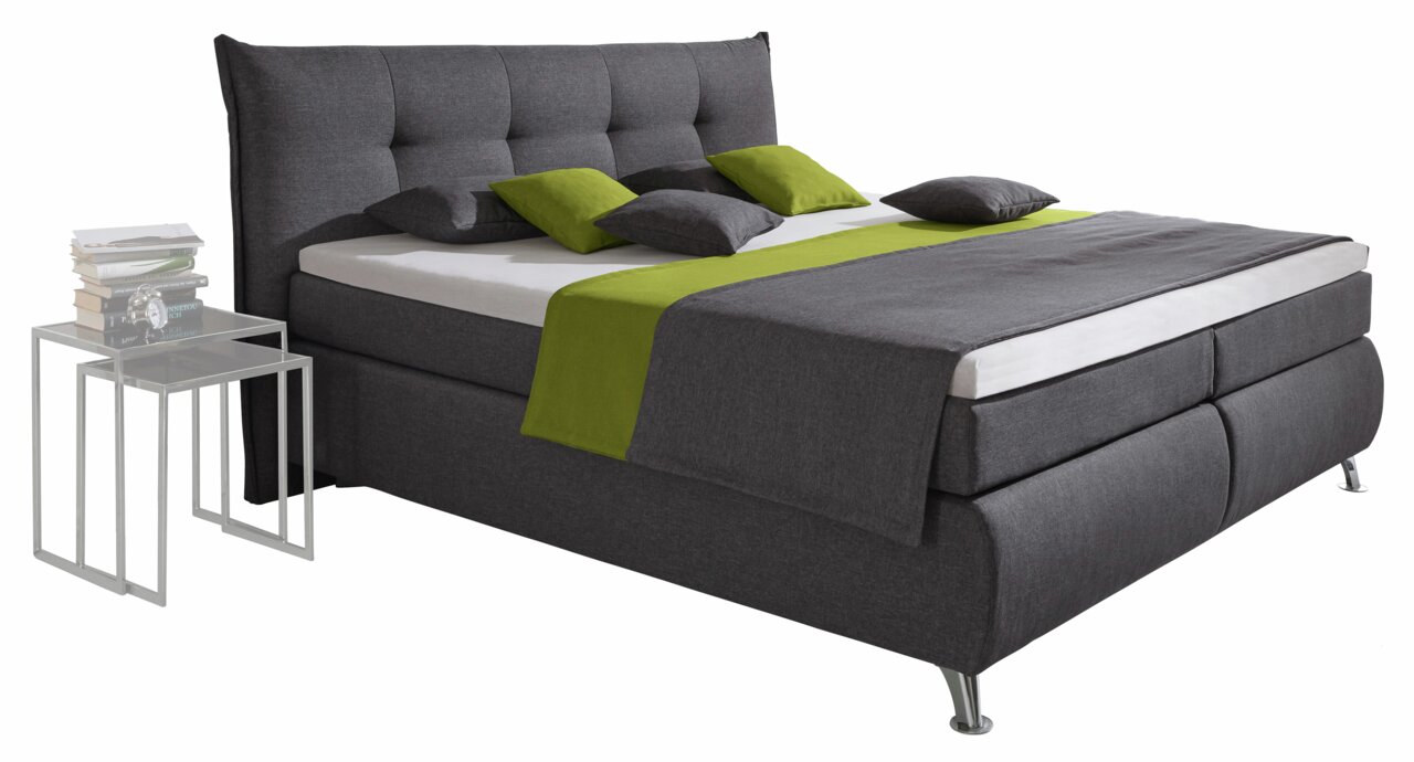 Boxspringbett in dunklem Grau mit grünem Akzent, seitliche Perspektive