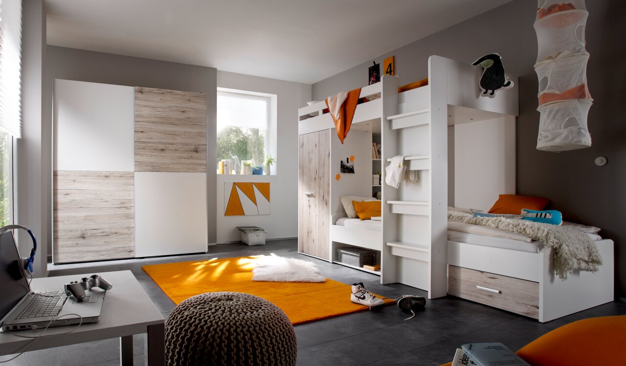 Modernes Hochbett in einem stilvollen Kinderzimmer mit grauen Wänden, einem Schreibtisch und einem orangefarbenen Teppich. Perspektive: seitliche Ansicht des Bettes.