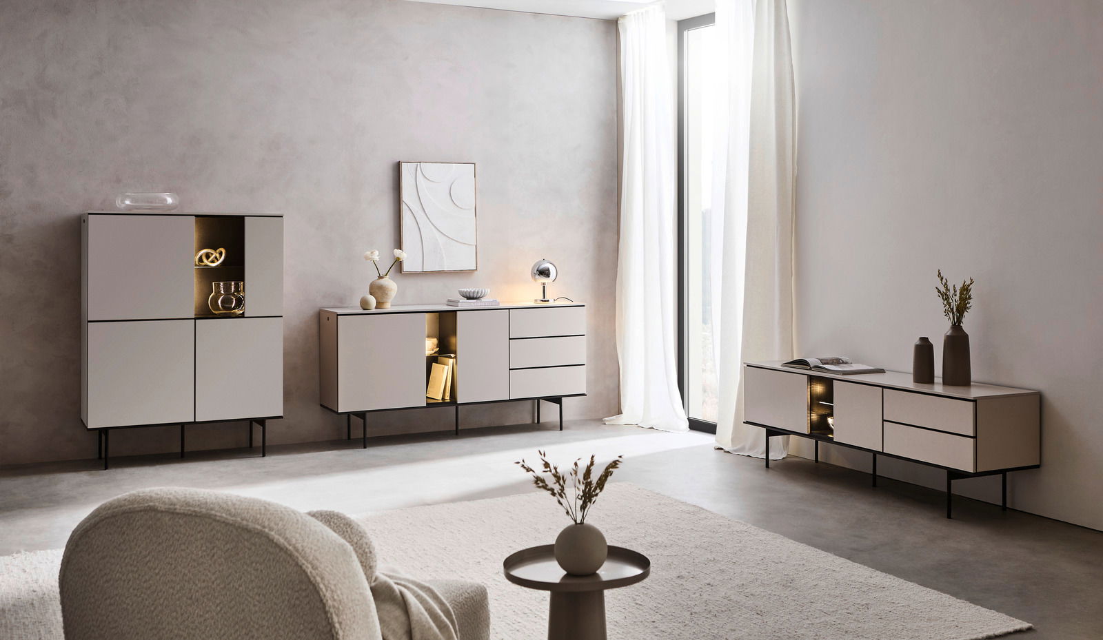 Moderne Wohnzimmermöbel in einem hellen Raum mit einem Sideboard, Highboard und TV-Lowboard in minimalistischer Perspektive.