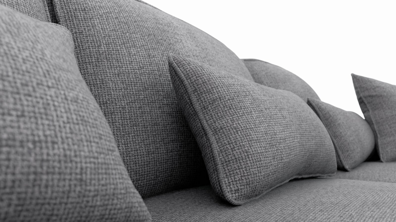 Nahaufnahme einer grauen Stoff-Rundecke mit mehreren Kissen, seitliche Perspektive