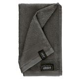 Graues Handtuchset aus Frottierstoff, gefaltet und von oben fotografiert.