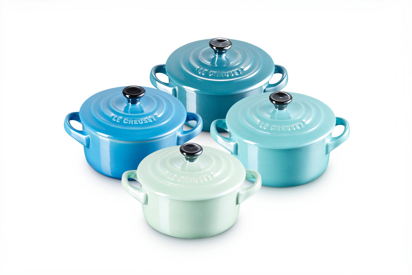 Vierer-Set Mini Cocotte in Blau-Grün, von oben betrachtet, mit glänzender Oberfläche und schwarzen Knöpfen.