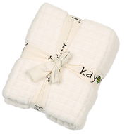 Weißes Plaid 150x220cm von Kayori, gefaltet und mit einem dekorativen Band gebunden, aus der Vogelperspektive.