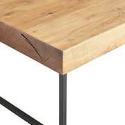 Detailansicht eines Couchtisches mit einer Tischplatte aus hellem Holz und dunklen Metallbeinen, Perspektive von der Ecke.