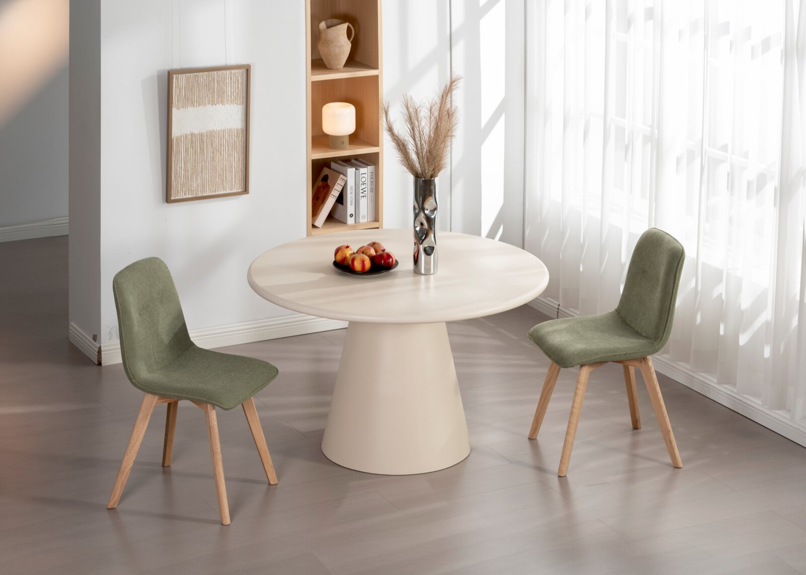 Twee groene stoelen met houten poten staan rond een ronde, crèmekleurige tafel in een lichte ruimte. Het perspectief toont de stoelen van opzij.