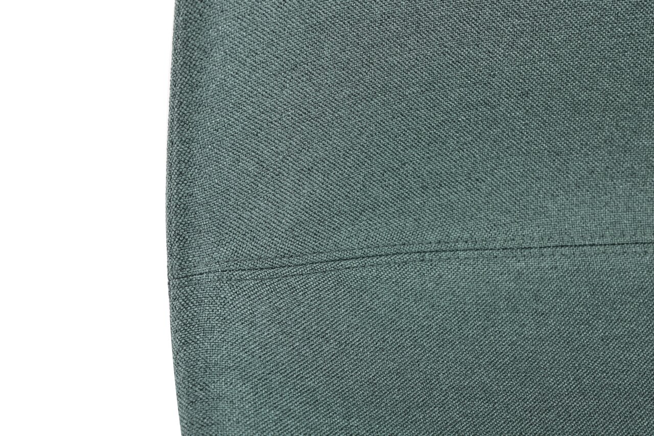 Nahaufnahme eines grünen Stoffbezugs eines Stuhls, Detailansicht der Textur.