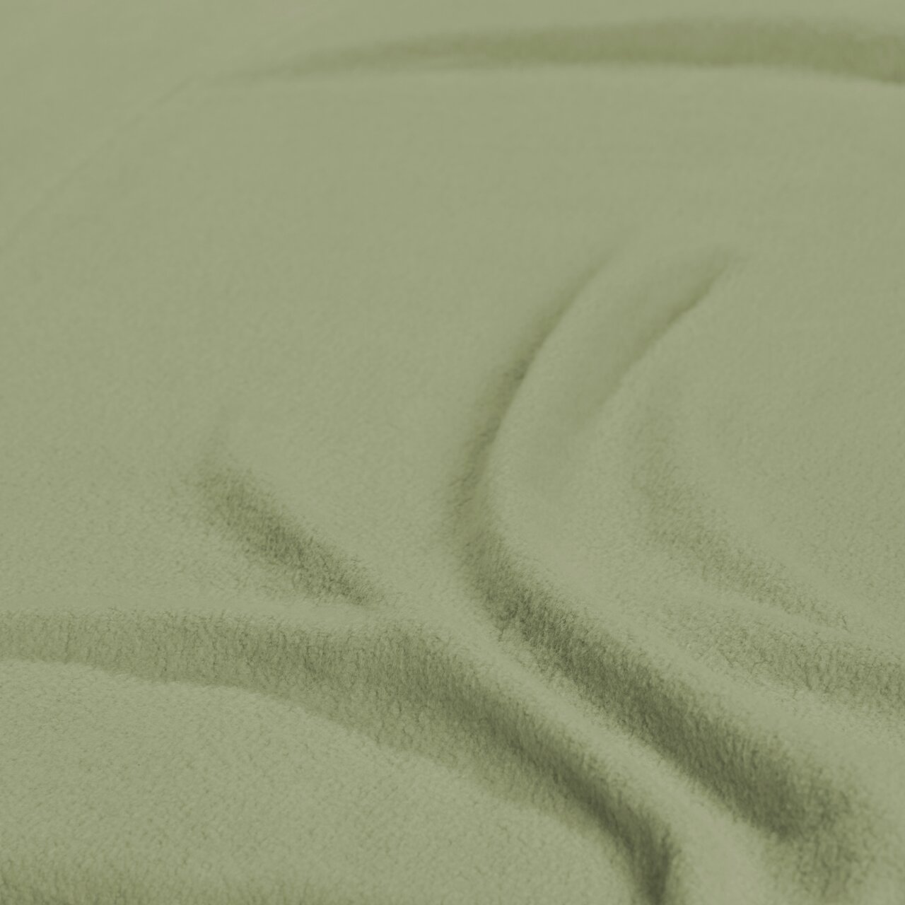 Nahaufnahme eines grünen Spannbetttuchs mit weicher Textur.