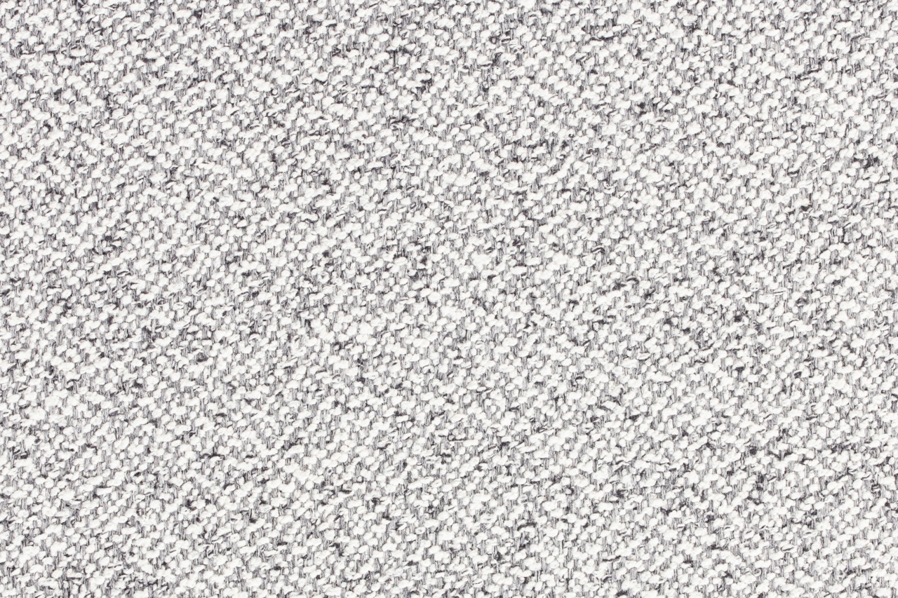 Nahaufnahme einer grauen, strukturierten Stoffoberfläche in Draufsicht