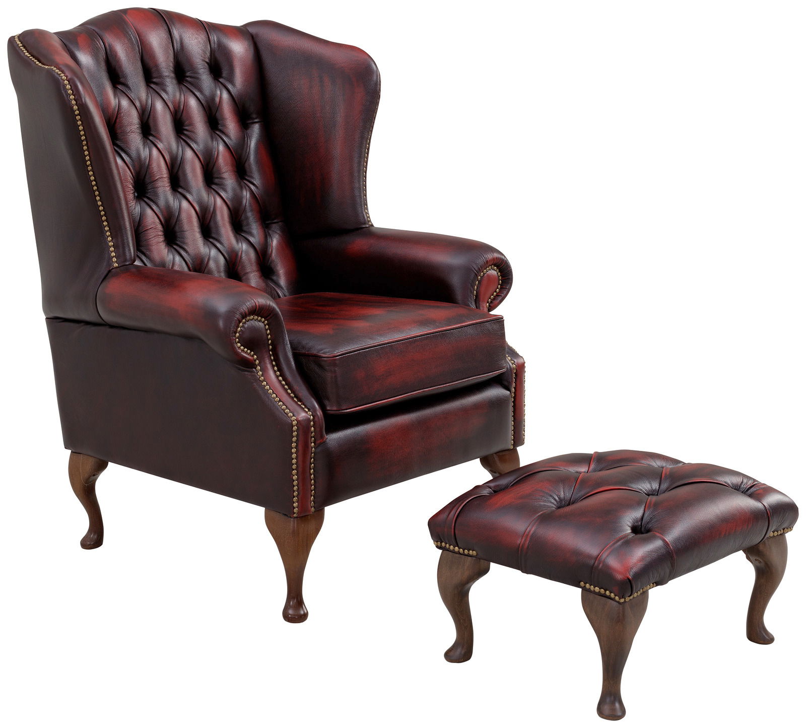 Klassischer Ohrensessel mit rotem Lederbezug und passendem Hocker, seitliche Perspektive