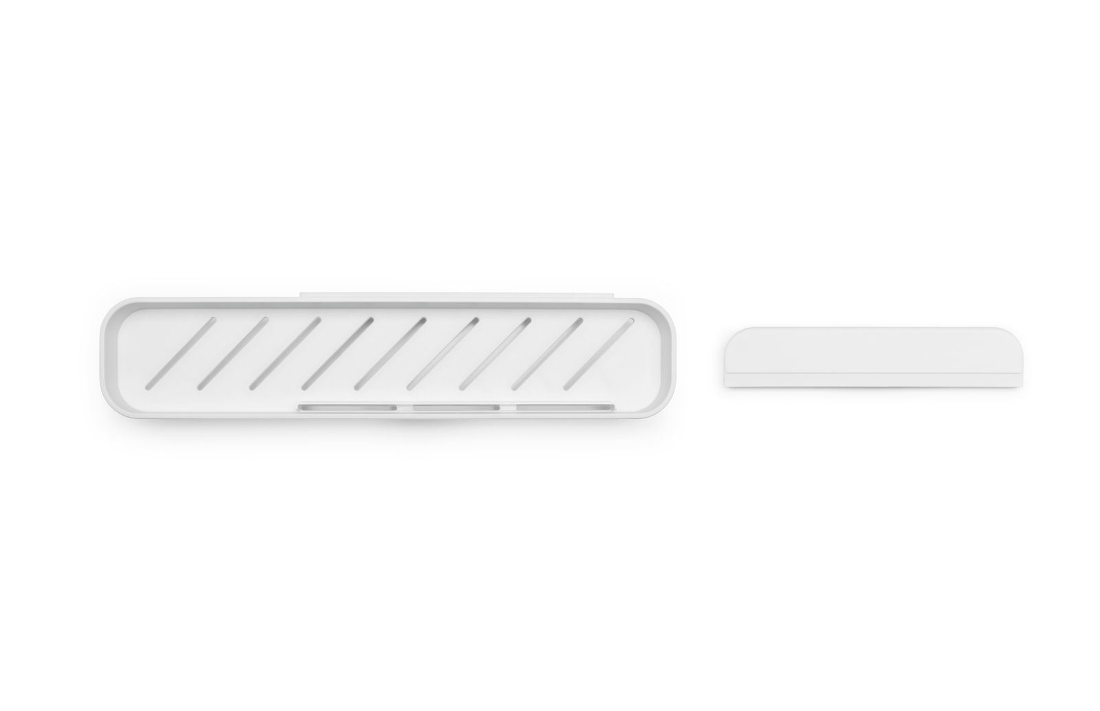 Duschablage aus weißem Material, von oben betrachtet, mit schmalem, länglichem Design und Rillen für Wasserabfluss.